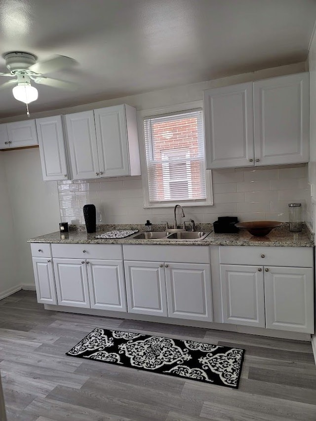 18639 Appoline St, Detroit, MI 48235 - kitchen with a sink, white cabinetry, and tasteful backsplash