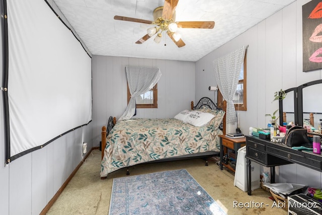 bedroom featuring a decorative wall and a ceiling fan