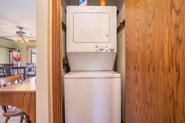 laundry area featuring ceiling fan, laundry area, and stacked washer and clothes dryer