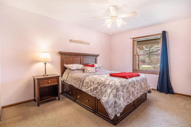 bedroom with light carpet, baseboards, and a ceiling fan