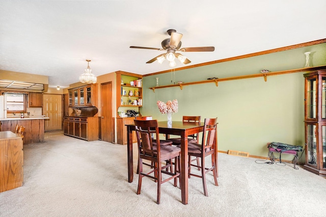dining area featuring light carpet, visible vents, and ceiling fan