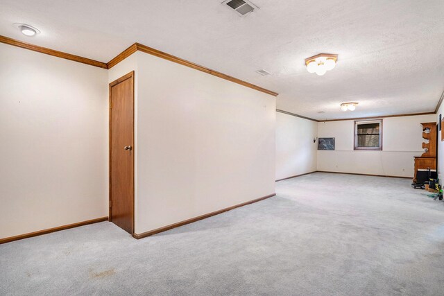 interior space with ornamental molding, visible vents, and carpet flooring