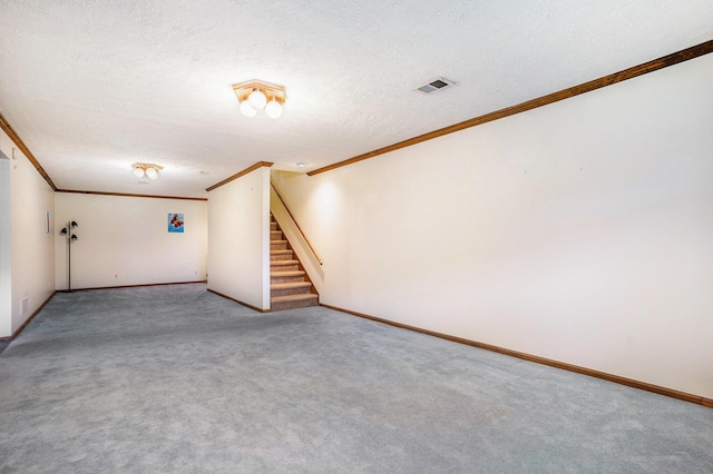 unfurnished living room with a textured ceiling, ornamental molding, visible vents, and stairs
