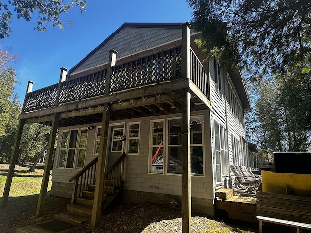 back of house with entry steps and a wooden deck