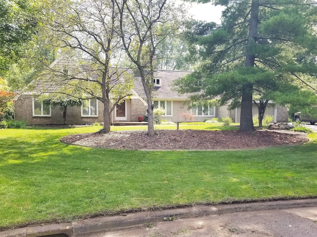 4717 Mohican Ln, Okemos, MI 48864 - view of front of house featuring brick siding and a front lawn