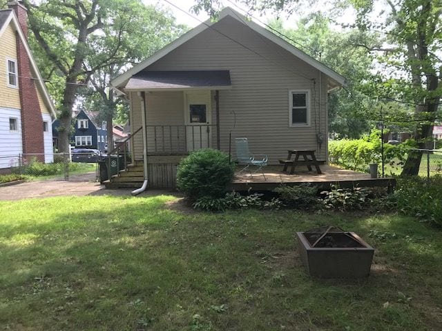 back of house featuring a yard and fence