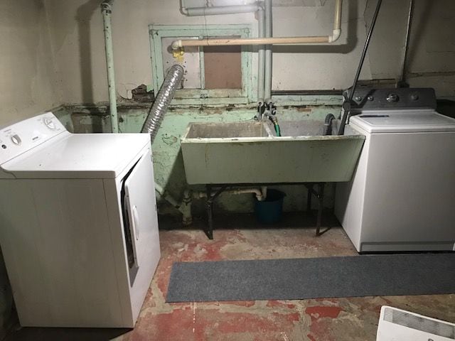 laundry area featuring a sink, washer and clothes dryer, and laundry area