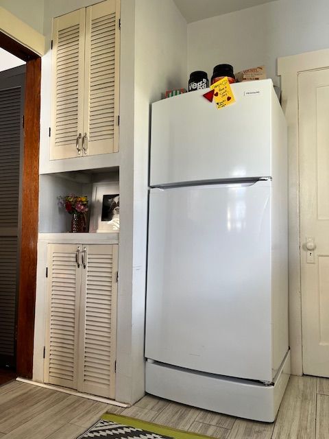 kitchen with freestanding refrigerator and light wood-type flooring