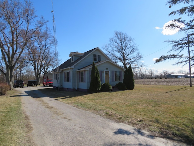 view of side of property featuring a yard and driveway
