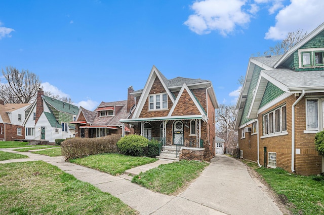 13605 Griggs St, Detroit, MI 48238 - view of front of house featuring a residential view, driveway, a front yard, brick siding, and covered porch