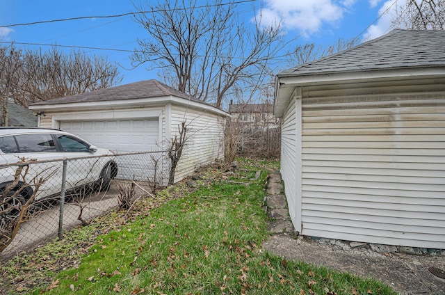 13605 Griggs St, Detroit, MI 48238 - exterior space with roof with shingles, fence, an outbuilding, and a detached garage