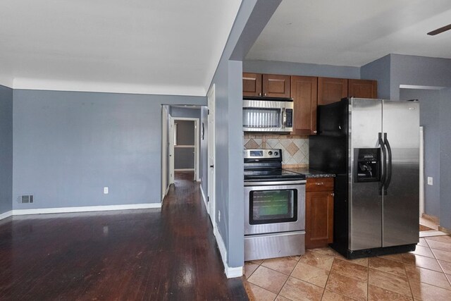 kitchen with visible vents, brown cabinets, decorative backsplash, and appliances with stainless steel finishes