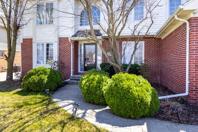 doorway to property featuring brick siding