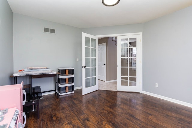 office featuring french doors, wood finished floors, and baseboards