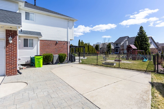 view of patio featuring a playground and a residential view