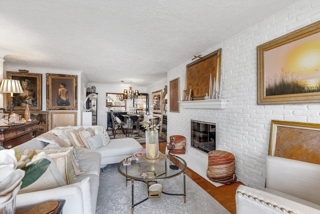 1750 Vernier Rd Unit 10, Grosse Pointe Woods, MI 48236 - living area with a chandelier, a textured ceiling, wood finished floors, and a brick fireplace