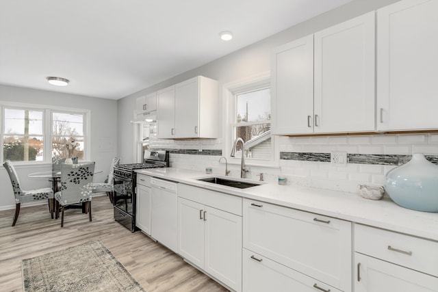 9136 Buckingham St, White Lake, MI 48386 - kitchen featuring gas stove, a sink, dishwasher, and healthy amount of natural light