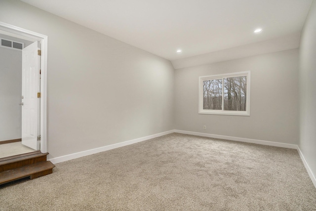 carpeted spare room with visible vents, baseboards, and recessed lighting
