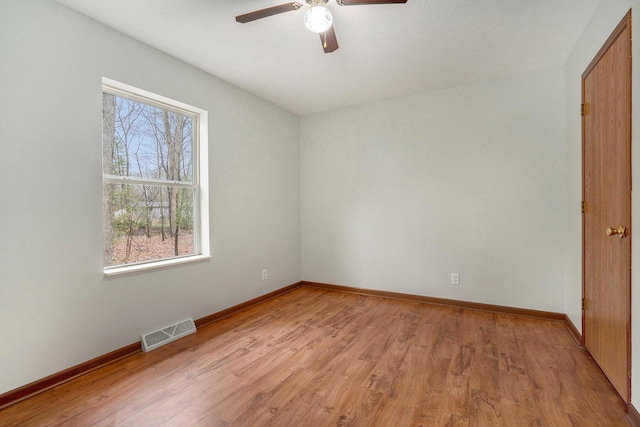 unfurnished bedroom with light wood-style floors, visible vents, baseboards, and ceiling fan
