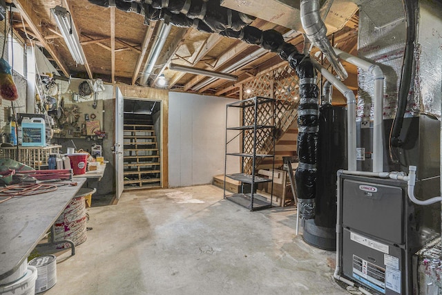 unfinished basement featuring stairs, a workshop area, and heating unit