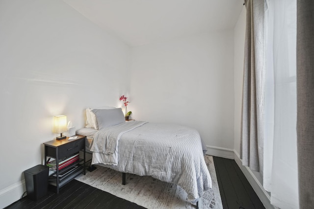 bedroom with wood finished floors and baseboards
