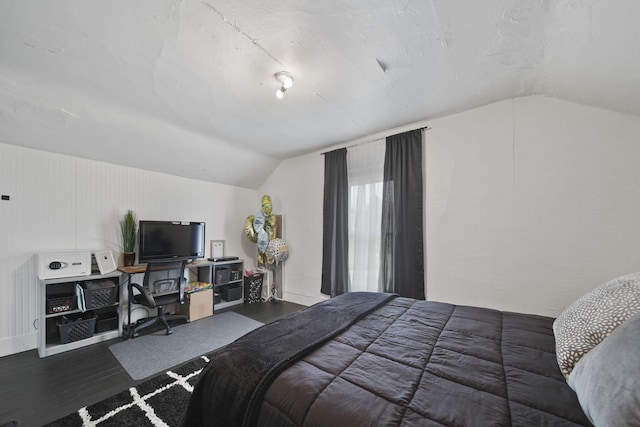 bedroom with wood finished floors and vaulted ceiling