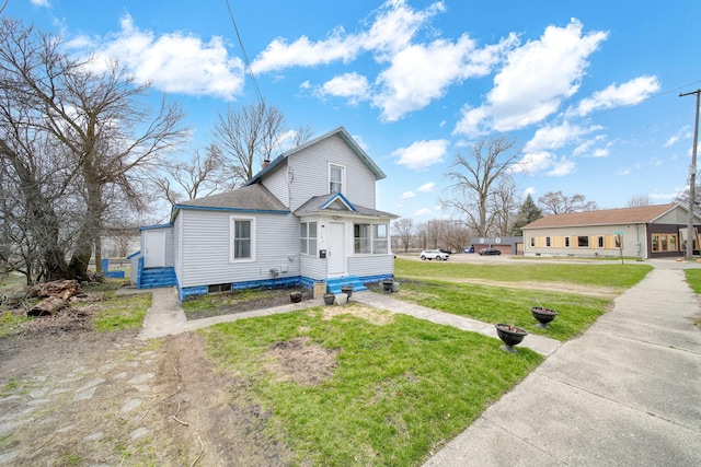 bungalow with roof with shingles and a front lawn