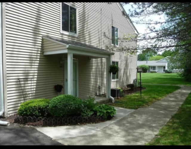 view of home's exterior with a yard