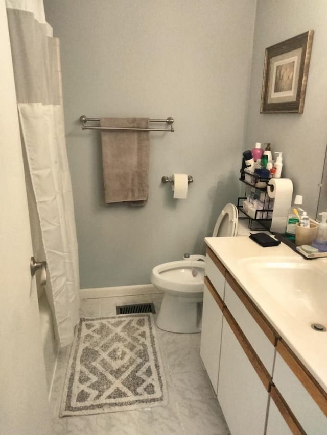 bathroom featuring vanity, a shower with curtain, visible vents, toilet, and tile patterned floors