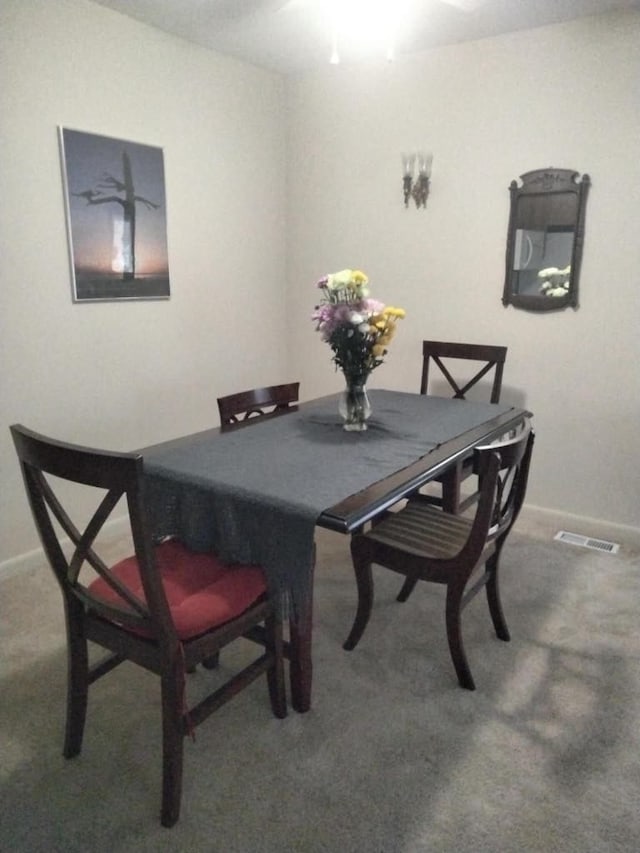 dining area featuring baseboards, visible vents, and carpet floors