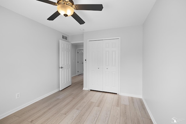 unfurnished bedroom featuring light wood finished floors, visible vents, and baseboards