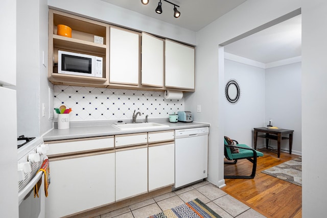 1209 Island Dr Unit 102, Ann Arbor, MI 48105 - kitchen featuring white appliances, a sink, tasteful backsplash, light countertops, and white cabinets