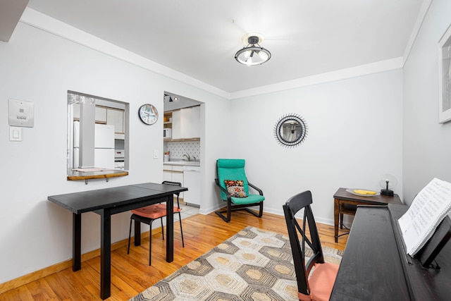 1209 Island Dr Unit 102, Ann Arbor, MI 48105 - home office with light wood-style floors, crown molding, baseboards, and a sink