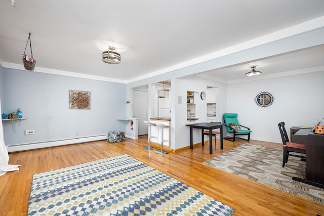 1209 Island Dr Unit 102, Ann Arbor, MI 48105 - living room featuring baseboard heating, wood finished floors, crown molding, and baseboards