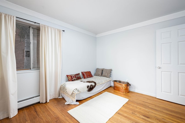 1209 Island Dr Unit 102, Ann Arbor, MI 48105 - bedroom featuring a baseboard radiator and wood finished floors