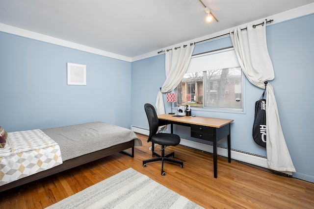 1209 Island Dr Unit 102, Ann Arbor, MI 48105 - bedroom with track lighting, a baseboard heating unit, and wood finished floors