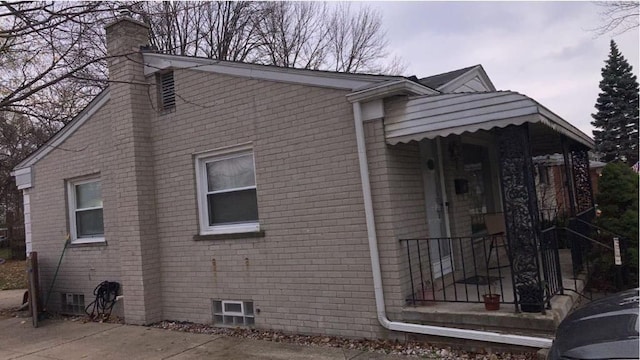 8021 Trafalgar St, Taylor, MI 48180 - view of side of property with brick siding and a chimney