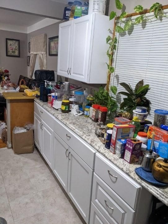 8021 Trafalgar St, Taylor, MI 48180 - kitchen with white cabinets and light stone counters