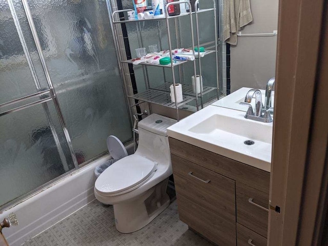 8021 Trafalgar St, Taylor, MI 48180 - full bath featuring tile patterned floors, toilet, combined bath / shower with glass door, and vanity