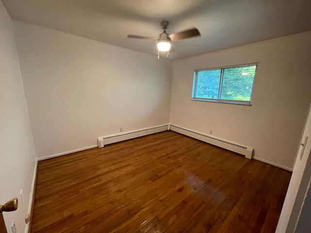 empty room with a ceiling fan, baseboard heating, baseboards, and dark wood finished floors