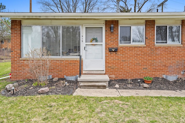 property entrance featuring brick siding