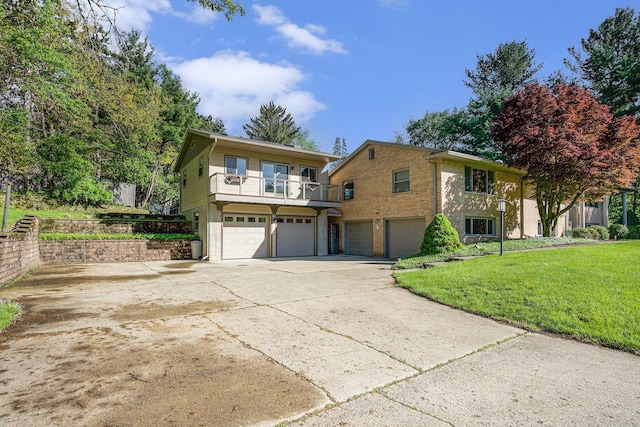 2693 Laurentide Dr, Ann Arbor, MI 48103 - view of front of house featuring a garage, concrete driveway, a balcony, and a front lawn