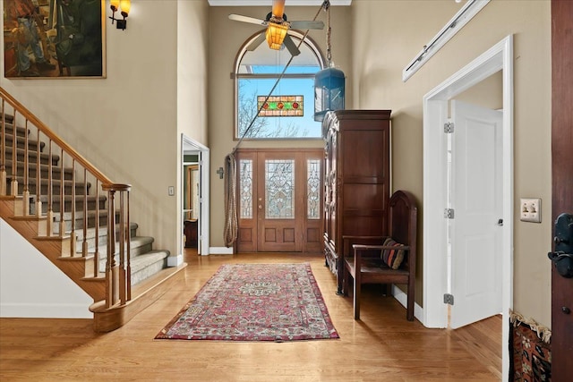entrance foyer with baseboards, a wealth of natural light, and stairway