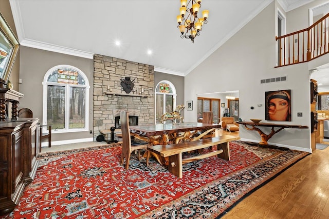 dining room with a fireplace, a chandelier, visible vents, and a healthy amount of sunlight
