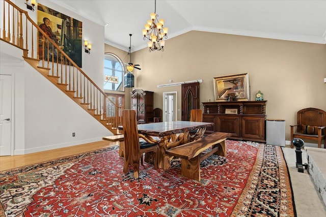 dining area with a notable chandelier, lofted ceiling, stairs, and ornamental molding