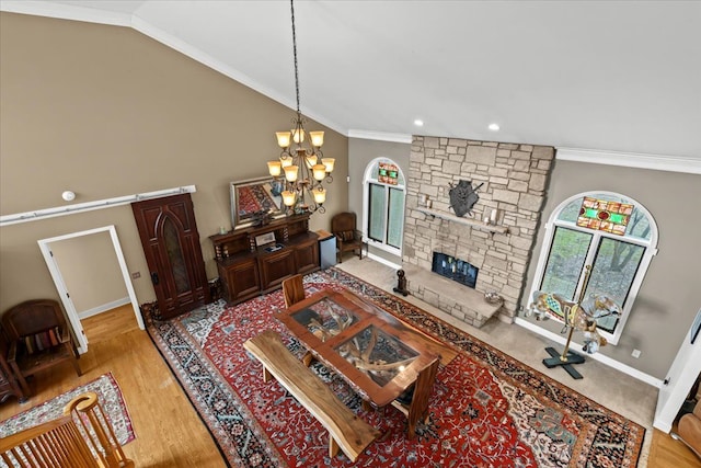 living area featuring baseboards, an inviting chandelier, ornamental molding, and a fireplace