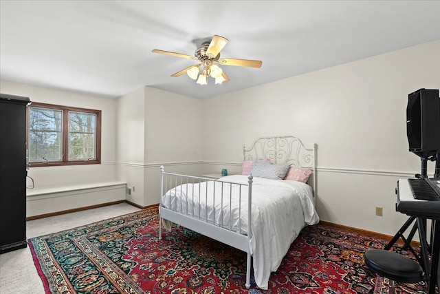 carpeted bedroom with baseboards and a ceiling fan