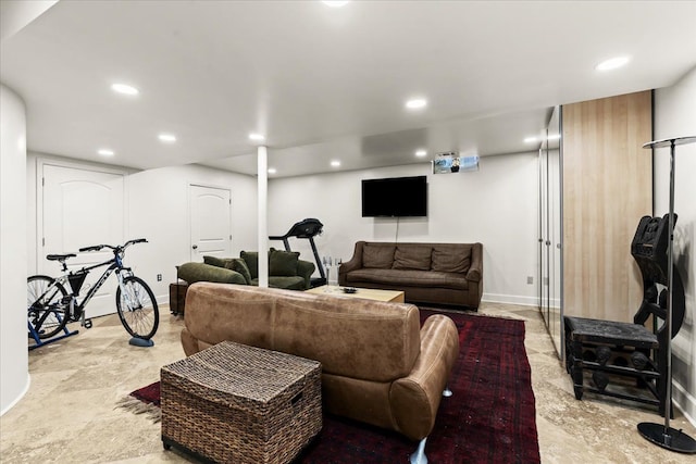 living room featuring baseboards and recessed lighting