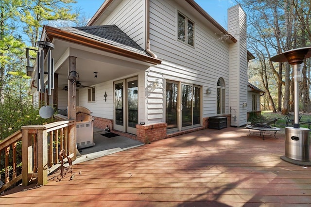 wooden terrace featuring an outdoor fire pit