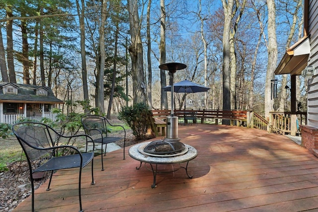 wooden terrace with a fire pit